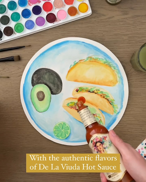 Screenshot of hand pouring hot sauce on illustrated place of tacos with caption 