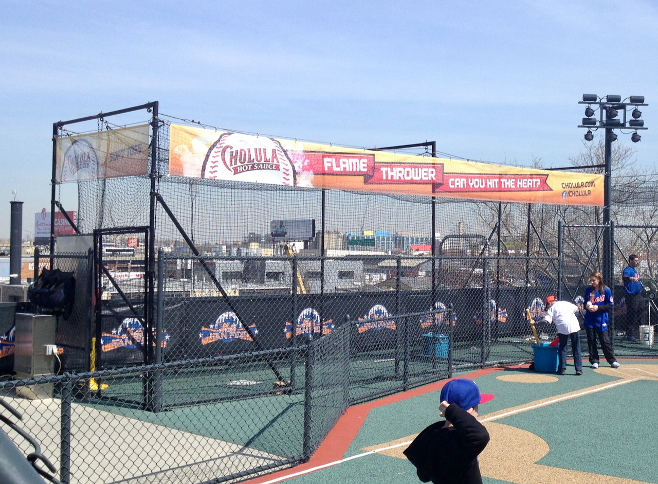 Pitcher cage branded with Cholula Flamethrower graphics