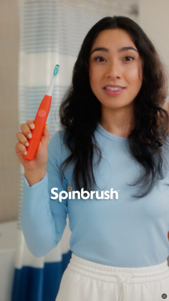 Woman holding Spinbrush